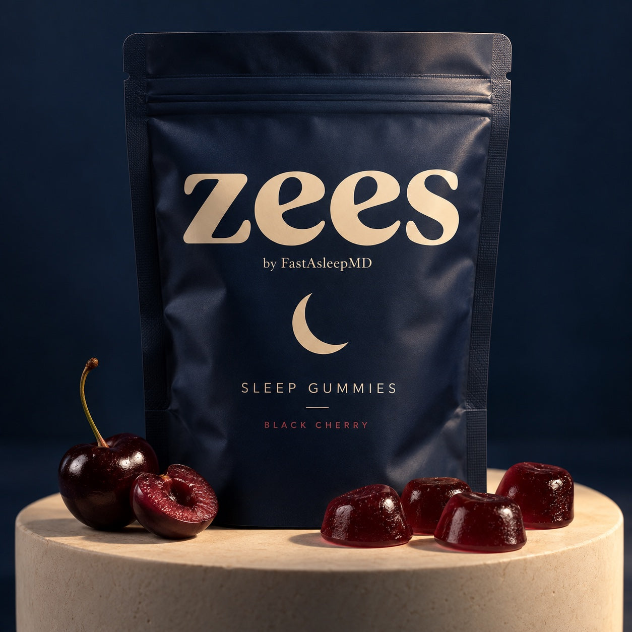 Midnight-blue Zees pouch with black cherries and pillow-shaped gummies